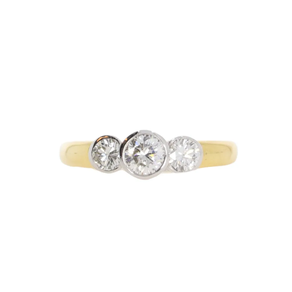 Diamond three stone ring, 18ct yellow gold rub over mount