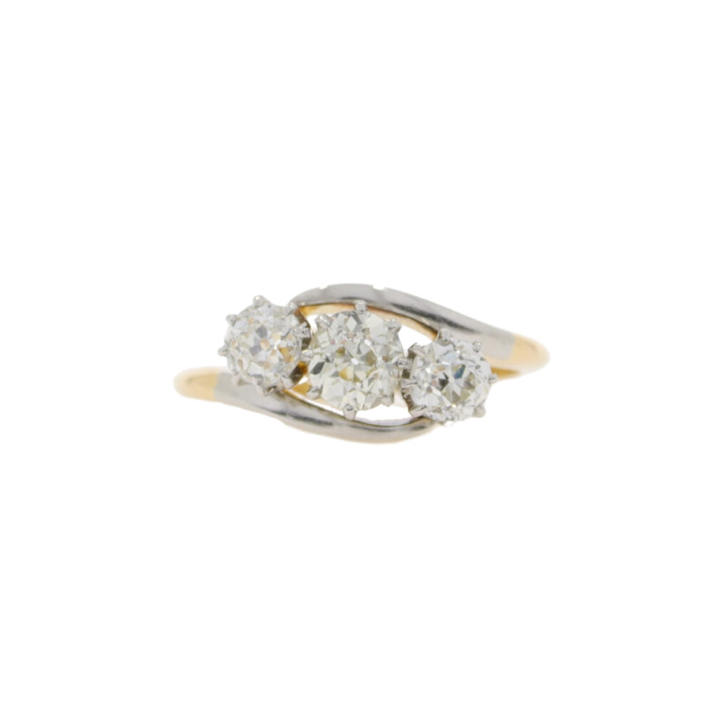 Diamond three stone crossover ring, platinum and 18ct gold mount