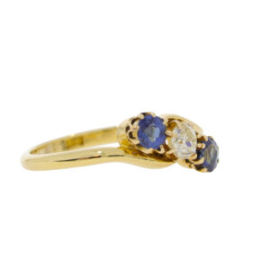 T113.4 Sapphire and diamond 3 stone crossover ring. side.jpg
